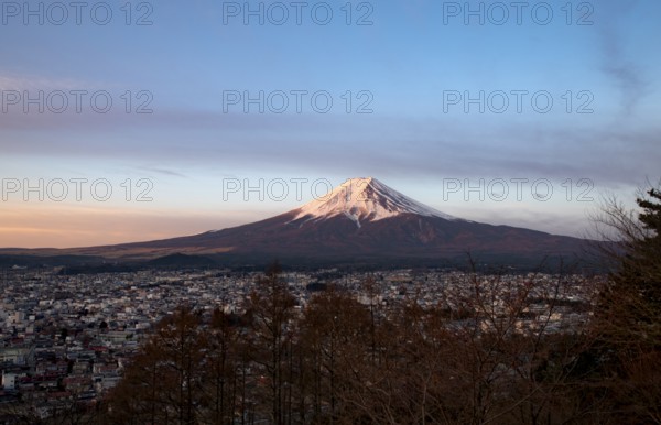 View of Mount Fuji volcano over Fujiyoshida City, at sunrise, Arakurayama Sengen Park, Yamanashi