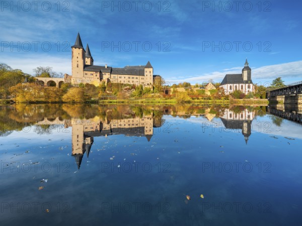 Rochlitz Castle and St. Peter's Church in autumn, perfect reflection in the Zwickauer Mulde river,