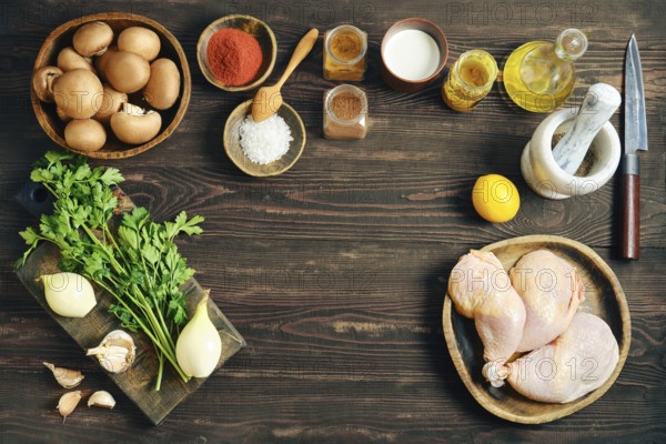 Top view of food ingredients for cooking including chicken meat, vegetables, spices and herbs