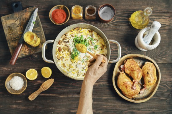 A person adds cardamon into pan with chopped mushrooms, onion, herbs and cream. Adding flavour to