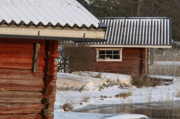 Snowy wooden huts in a winter landscape, Korpoström, Korpo or Korppo, southwestern archipelago,