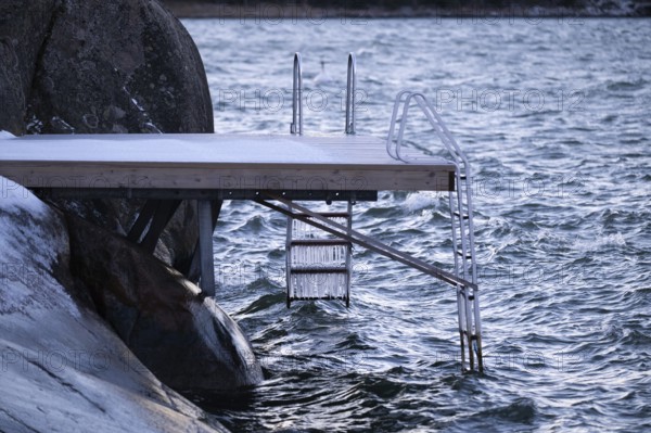 Jetty on a wintry coast with waves and icicles on a staircase, Korpoström, Korpo or Korppo,