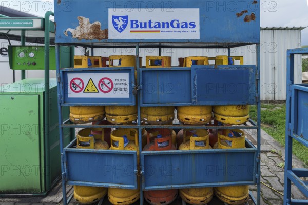 Sales rack with butane gas bottles at a gas station, Romania
