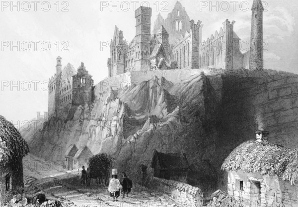 Gothic cathedral ruin on the Rock of Cashel, County Tipperary, Ireland, street, people, cottages,