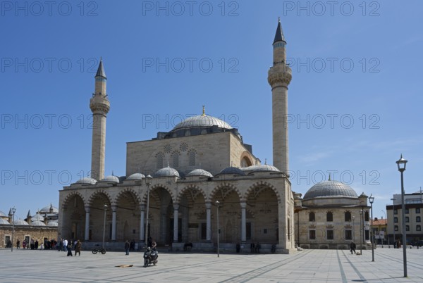 A historic mosque with two minarets and multiple domes under a clear blue sky, mosque, Konya Sultan