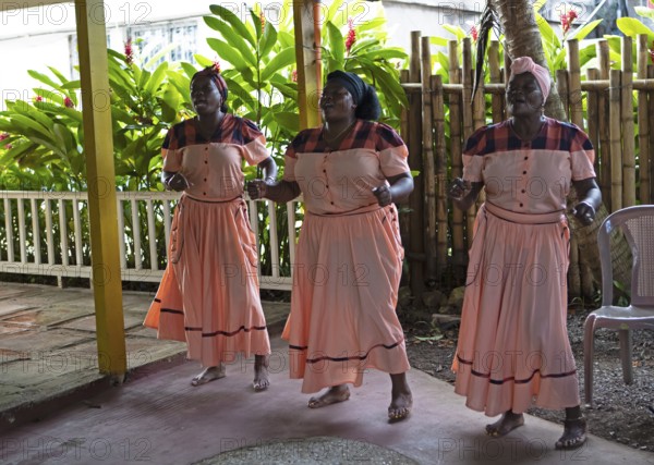Guatemalan woman in traditional clothing singing and dancing, Garifuna people, Livingston, Izabal