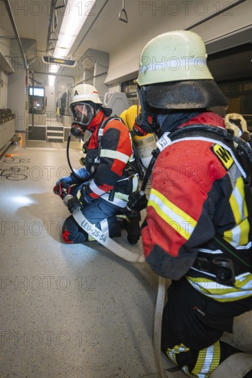 Firefighters are getting ready for a mission inside a train, fire brigade exercise on the Hermann