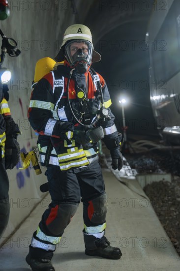 A firefighter in full protective clothing with respirator in the tunnel, fire department exercise