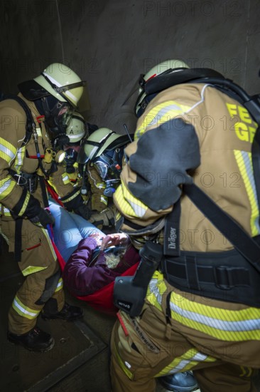 Firefighters free a person in a tunnel with a stretcher, fire brigade exercise on the Hermann Hesse