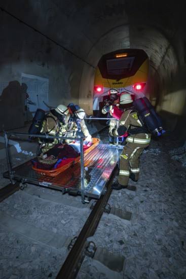 Firefighters carry out a rescue on rails in a tunnel, fire brigade exercise on the Hermann Hesse