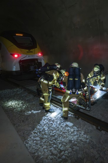 Firefighters carry out a rescue operation next to a train in a tunnel, fire brigade exercise on the