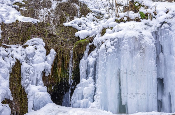 Urach waterfall full of bizarre ice formations frozen at winter temperatures, Bad Urach, Swabian