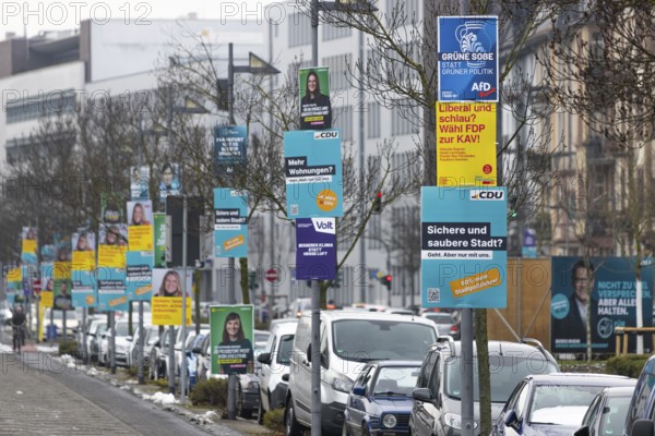 Numerous election posters for the 2026 local elections are hanging one behind the other on several