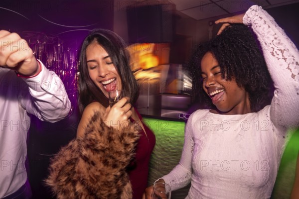 Diverse group of young women friends having fun laughing and celebrating together, enjoying the