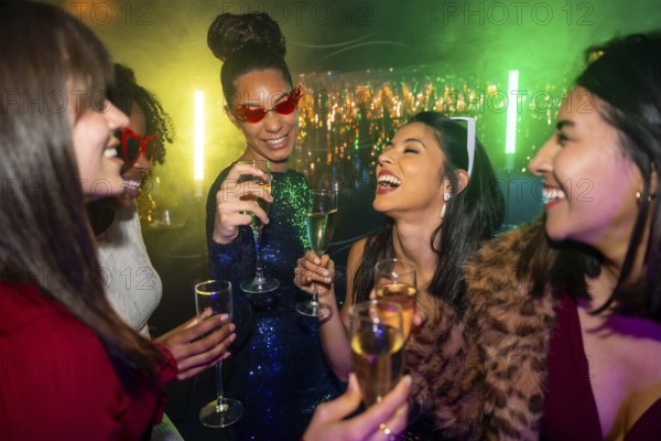 Joyful multiracial women laughing and clinking champagne glasses at a vibrant nightclub party,