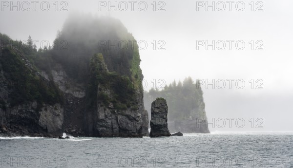 Mystical fog sweeps around rocky islands on the coast, Kenai Fjords National Park, Kenai Peninsula,
