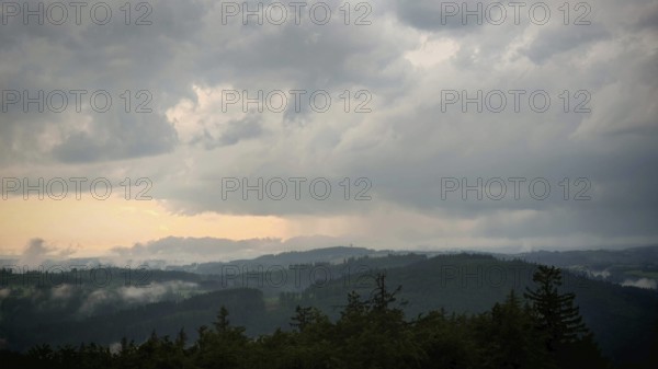 Dense clouds cover the mountain landscape and create an oppressive atmosphere, Fichtelgebirge