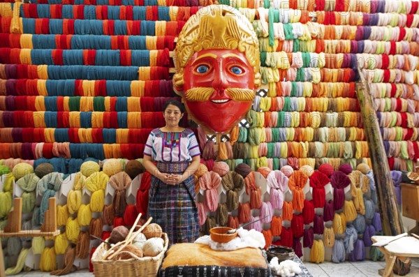 Maya woman, 42 years old, next to a mask of a Moro or Moor for the traditional mask dance, behind a