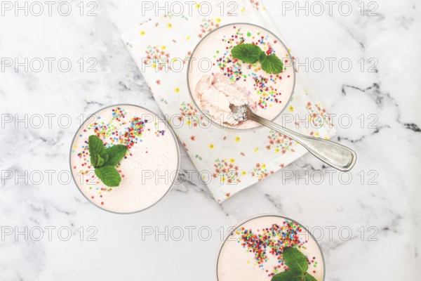 Fruit mousse, made from jelly and cottage cheese, in glasses, decorated with sprinkles and mint,