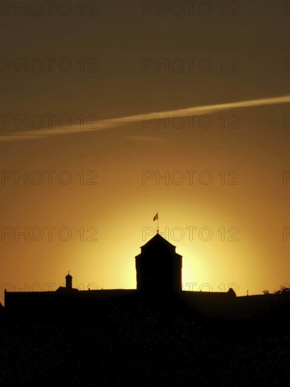 Silhouette of a historic building, Rosenberg Fortress with dramatic sunset in the background,