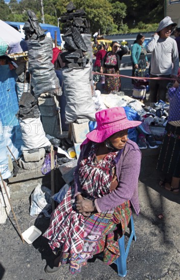 Mayan woman in traditional clothing selling charcoal at the market in Sololá, Highlands, Sololá
