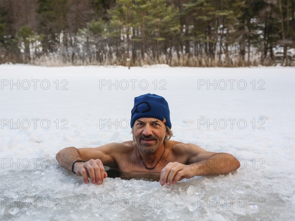 Man with cap, 55, ice bathing in an ice hole, Thumsee, Bad Reichenhall, Berchtesgadener Land, Upper