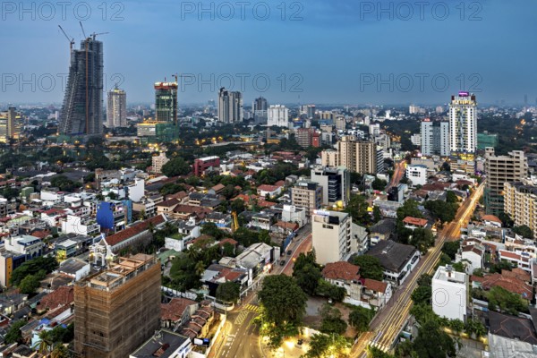 Evening city view with illuminated buildings and street lights, the skyline of Colombo in Sri Lanka