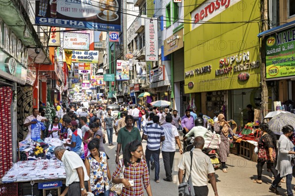 Bustling shopping street full of people, market stalls and glowing signs, the hustle and bustle of