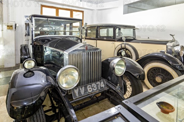 Black classic cars in a museum room, polished look, early automotive history design, classic car in