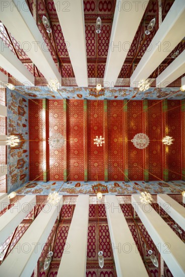 Frog's-eye view: Ubosot (ordination hall) with columns (Sao) and richly decorated ceiling (Phra
