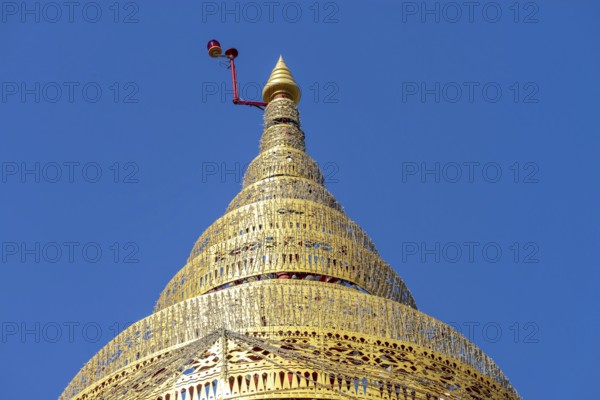 Umbrella over the Buddha statue in Wat Intharawihan, a ceremonial, often multi-level symbol of