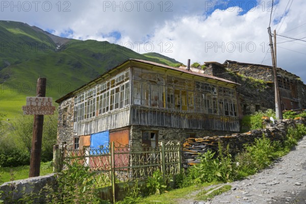 Rustic house on a mountainside under a cloudy sky, traditional house, Ushguli, Shibiani district,
