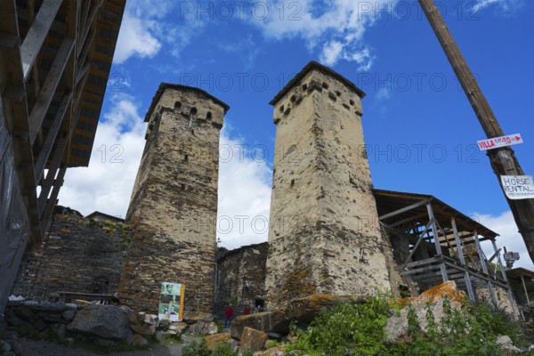 Two old stone towers under a cloudy sky, defensive towers, Ushguli, Ushguli, Shibiani district,
