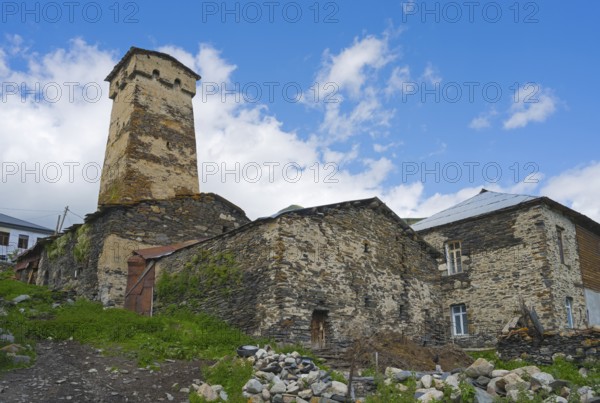 Old stone ruin with defence tower against a cloudy sky, defensive tower, Ushguli, Shibiani