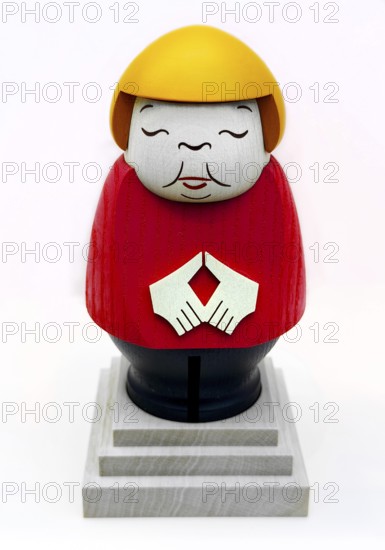 An avenger figure from the Ore Mountains depicts former federal chancellor Angela Merkel in black