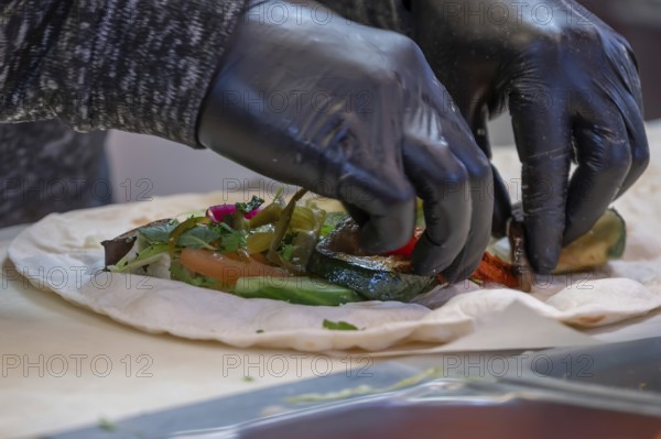 Preparation of falafel with vegetables at a falafel stand in the pedestrian zone, Nuremberg, Middle