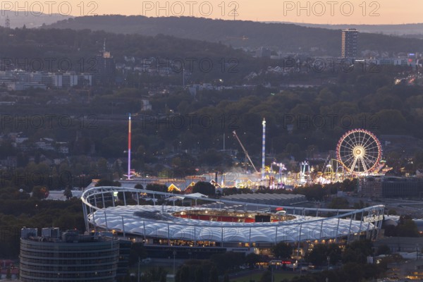 29 Sep 2018 at dusk, Volksfest lights seen from Rotenberg chapel with stadium foreground and