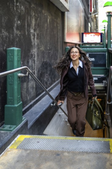 Young businesswoman with a confident smile and flowing hair, carrying a professional bag and a