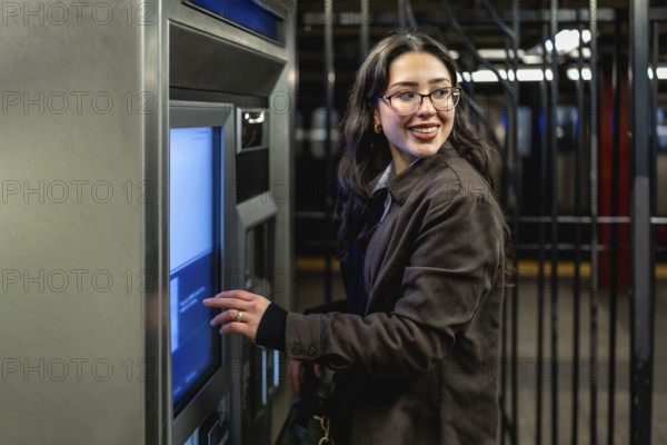 Young businesswoman with glasses and dark coat smiling, looking over her shoulder while interacting
