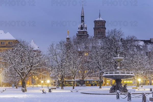 Winter in Stuttgart. The city is wintry white early in the morning. Castle square with fountain and