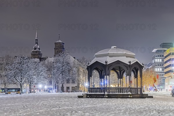 Winter in Stuttgart. The city is wintry white early in the morning. Palace Square with bandstand