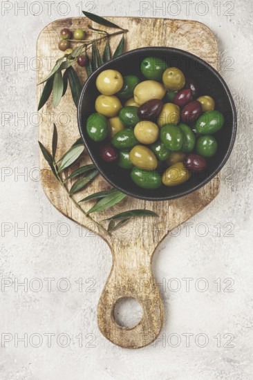 A mixture of olives, varieties of chalkidiki, Verdi giganti and Kalamata, in a bowl, top view, no