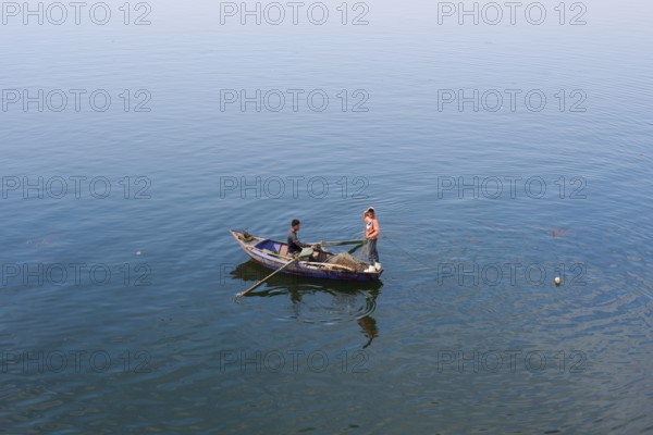 Boys in a rowboat fishing on the Nile, Luxor, Egypt