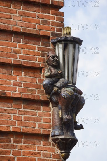 Lantern and sculpture on a house wall, Plön, Holsteinische Schweiz nature park Park,