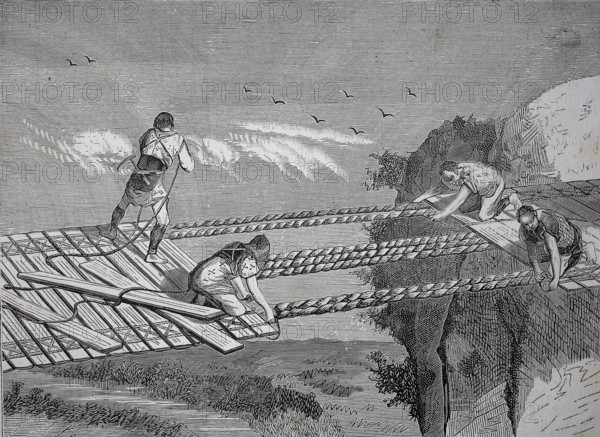 A rope bridge, dew bridge, suspension bridge whose walkway follows the sagging suspension cables,