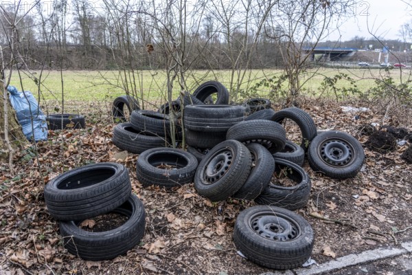 Illegally disposed of car tires and other trash, on a side street in Duisburg-Kaiserberg, North