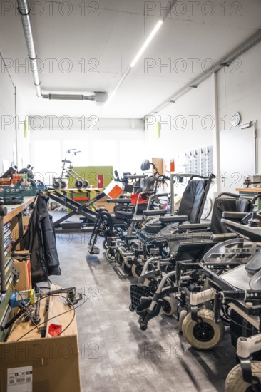 Spacious workshop with wheelchairs and rehabilitation equipment, clean and modern, medical supply