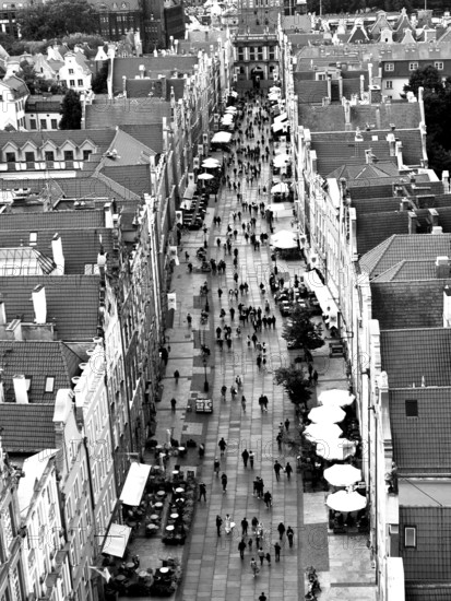 Aerial view of a busy urban street lined with historic buildings in black and white, view from St.