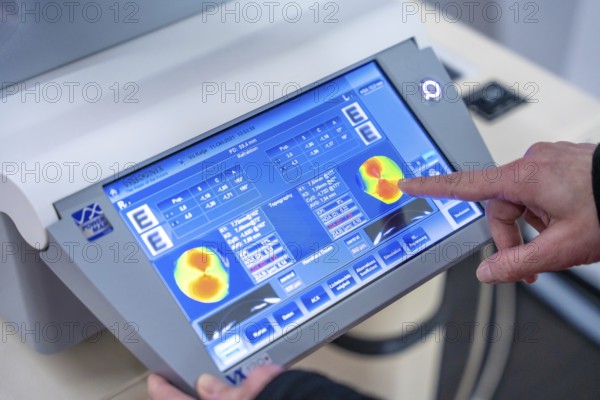 Close-up of touchscreen medical device being operated, optician, Pforzheim