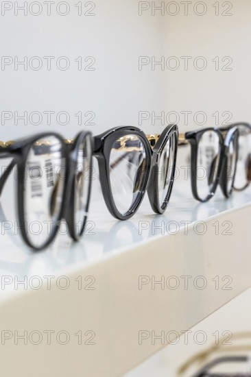 Several black eyeglass frames on a shelf in an optician's shop, optician, Pforzheim
